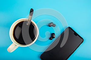 Top view Coffee and smartphone with Wireless bluetooth headphones