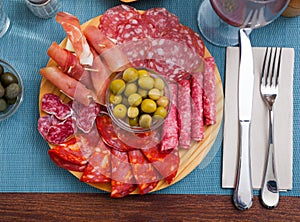 Top view of coldcuts of jamon, sausages on wooden board