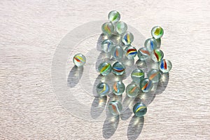 Top view of collection of shiny marbles on wooden background