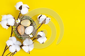 Top view of color easter haqndmade eggs and nest flatlay. Trendy minimal design spring background. Space for text. Stuio
