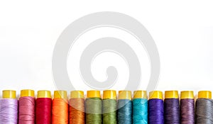 Top view of color sewing threads on white background