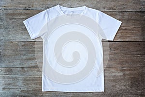 Top view of color T-Shirt on grey wood plank