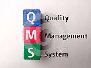 Top view colored block with text QMS quality management system photo