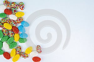 Top view of colored candy on a white background with space next to it