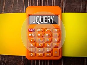 Top view colored notebook and calculator with text JQUERY