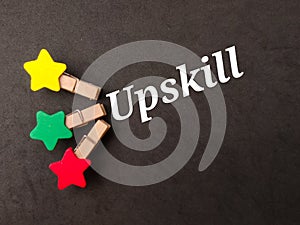 Top view colored wooden clips with text Upskill