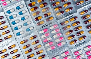 Top view of colorful antibiotic capsule pills in blister pack. Antibiotic drug resistance. Pharmaceutical industry. Pharmacy drug