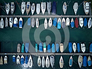 Top view of colorful boats and yachts parking by the docks of a marina on Lake Lucerne, in Fluelen