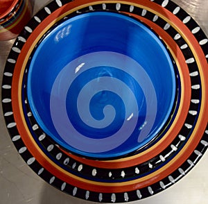 Top view of colorful ceramic bowls and plates on the table