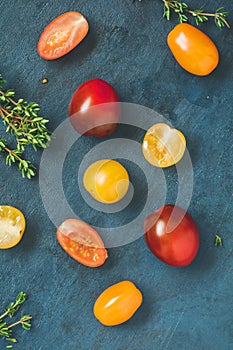 Top view of colorful cherry tomatoes on a blue table