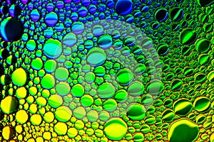 Top view on colorful drops of oil on the water. Circles and ovals. Abstract bright background for design