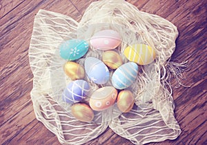 Top view of colorful easter eggs on cloth, retro filter effe