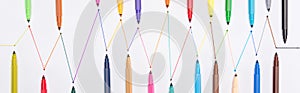 Top view of colorful felt-tip pens on white background with connected drawn lines, connection and communication concept.