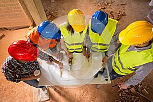 Top view of colorful hard hats of architects at construction sit