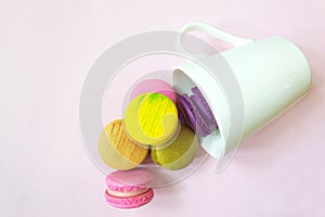 Top view of colorful macarons in cup