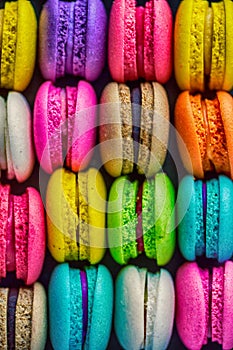 Top view colorful macarons dessert with vintage pastel tones.