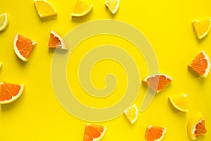 Top view of colorful orange fruit on pastel background.