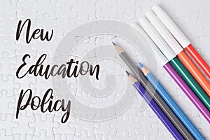 Top view of colorful pencils on a white puzzle with "New Education Policy" text photo