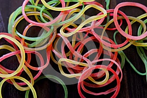 Top view of colorful rubber bands  on brown wooden