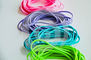 Top view of colorful rubber bands isolated on white.