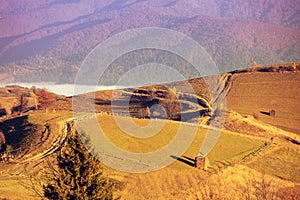 Top view of the colorful slopes of the mountains on an autumn sunny day