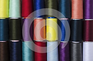 Top view of colorful spool of thread as a background.Rows of bobbins