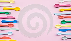 Top view of colorful spoon and fork element on color table.flat lay