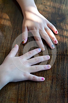 Top view of colorful stickers on the little girl's hand