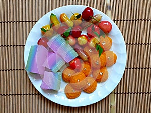 Top view The colorful sweet Thai desserts on bamboo mat background,