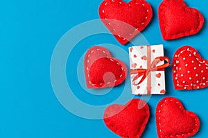 Top view colorful valentine background made of gift boxes and red textile hearts. Valentine\'s Day concept with copy space
