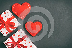 Top view colorful valentine background made of gift boxes and red textile hearts. Valentine\'s Day concept with copy space