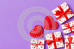 Top view colorful valentine background made of gift boxes and red textile hearts. Valentine\'s Day concept with copy space