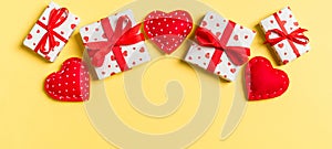 Top view colorful valentine background made of gift boxes and red textile hearts. Valentine\'s Day concept with copy space