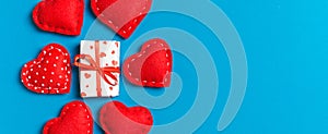 Top view colorful valentine background made of gift boxes and red textile hearts. Valentine\'s Day concept with copy space