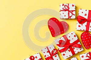 Top view colorful valentine background made of gift boxes and red textile hearts. Valentine\'s Day concept with copy space