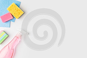 top view of colorful washing sponges and spray bottle,