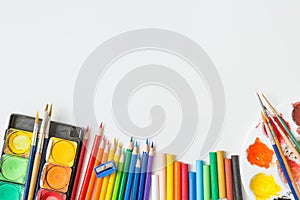 Top view of Colorful Watercolor palette, paintbrush, colored pencils, ruler and drawing equipment  on white background and copy