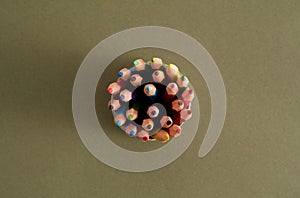 Top view of colorful wood pencils in a circle box, top view
