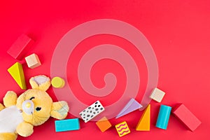 Top view of colorful wooden bricks on the table. Early learning. Educational toys on a red background