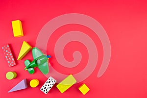 Top view of colorful wooden bricks on the table. Early learning. Educational toys on a red background