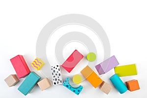 Top view of colorful wooden bricks on the table. Early learning. Educational toys on a white background