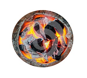 Top view, combustible charcoal has a flame in the grill, isolated white background