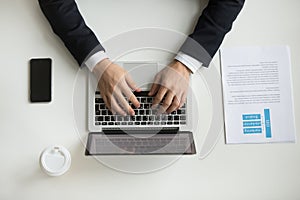 Top view of company CEO typing at laptop photo