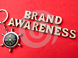 Top view compass and wooden word with text BRAND AWARENESS