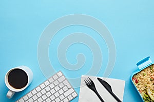 Top view of computer keyboard, cup