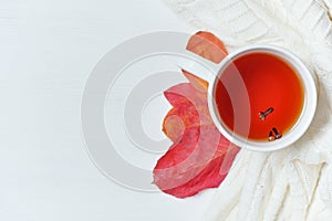 Top view concept autumn with tea and dry leaves on white wooden background