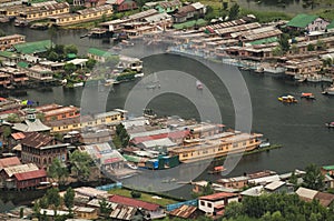 Top view of congested houseboats, shikara, boats, and houses in blue waters of Dal Lake. Jammu and Kashmir, India