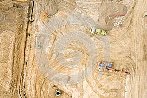 Top view of construction site. excavators and dump trucks loading sand before road construction