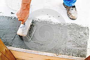 Top view of construction worker using paint brush for applying waterproof sealant