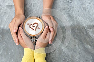 Top view with copy space. Couple in love holding hands with coffee love on table.